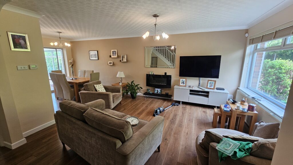 Renovated living room and dining area with fresh paint finish and warm modern interior styling