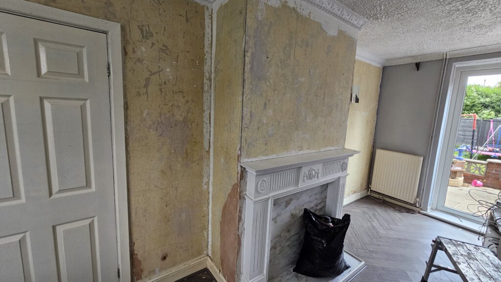 Fireplace wall during preparation before wallpapering and painting in a living room renovation