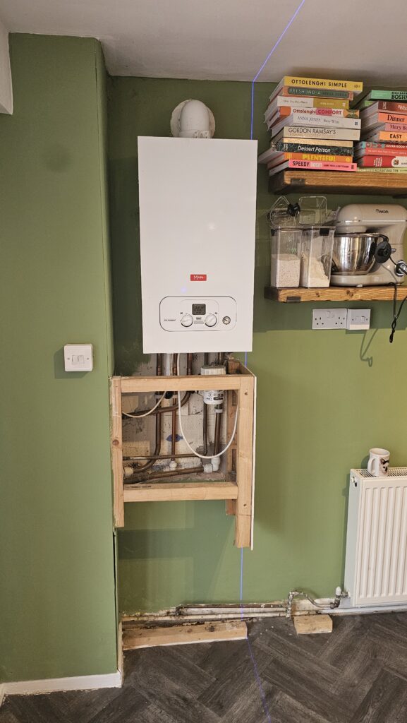 Boiler and exposed pipework before boxing and storage installation