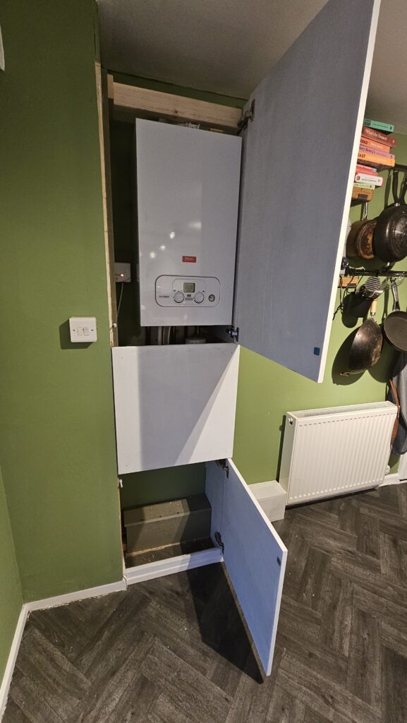 Boiler boxing with opening access panels and lower storage compartment