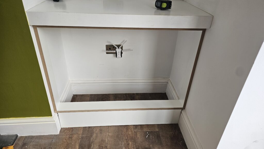 Media wall lower storage section being framed before cupboard doors were fitted