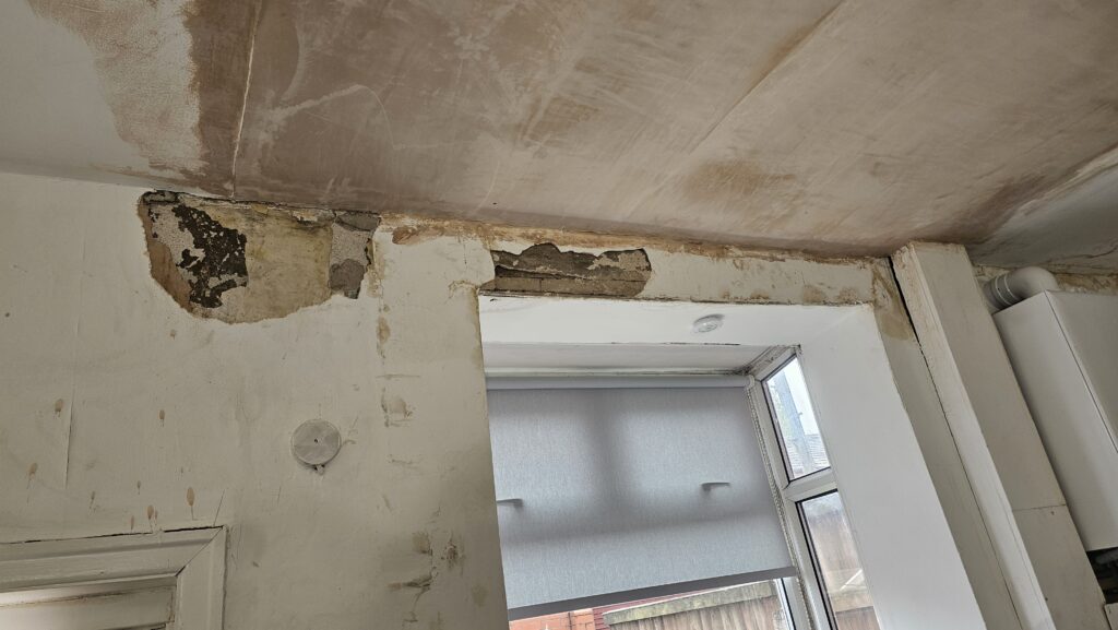Damaged kitchen wall and ceiling area before plastering and repair work