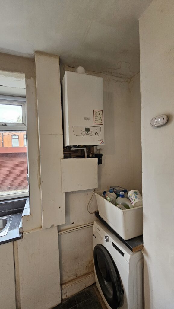 Kitchen utility corner before boxing and refurbishment work around the boiler area