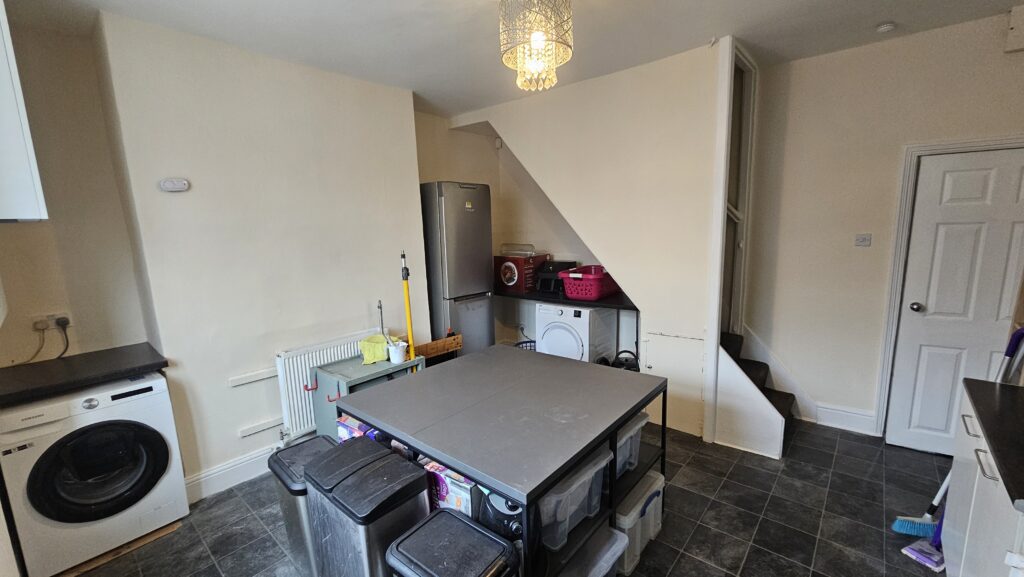 Refurbished kitchen with painted walls, repaired surfaces and a clean finished layout