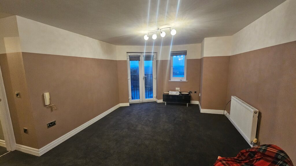 Completed living room painting project with refreshed walls and a clean updated finish