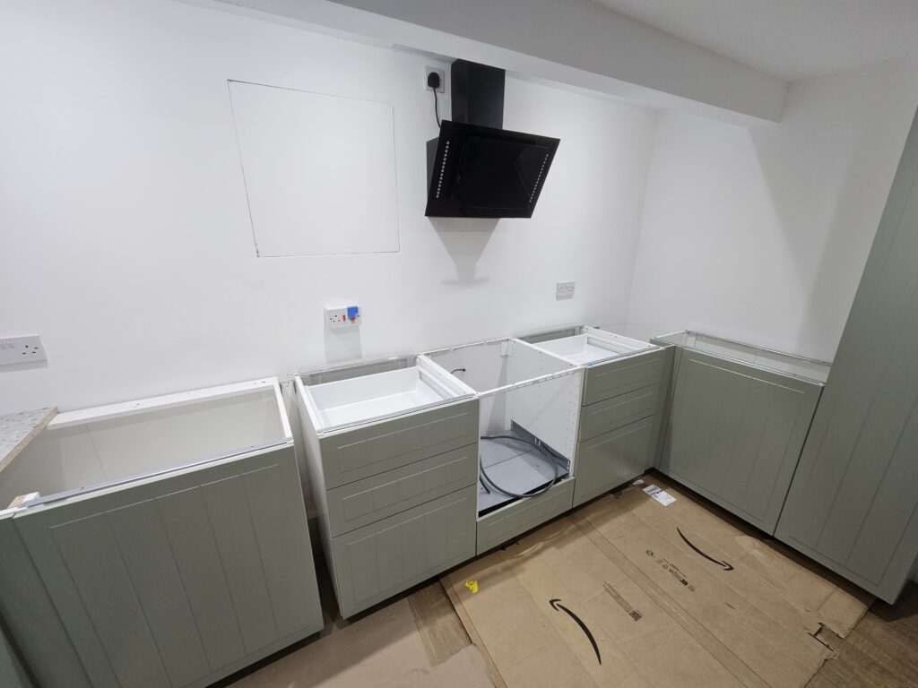 Kitchen base units prepared for new worktop installation before sink and hob cut-outs