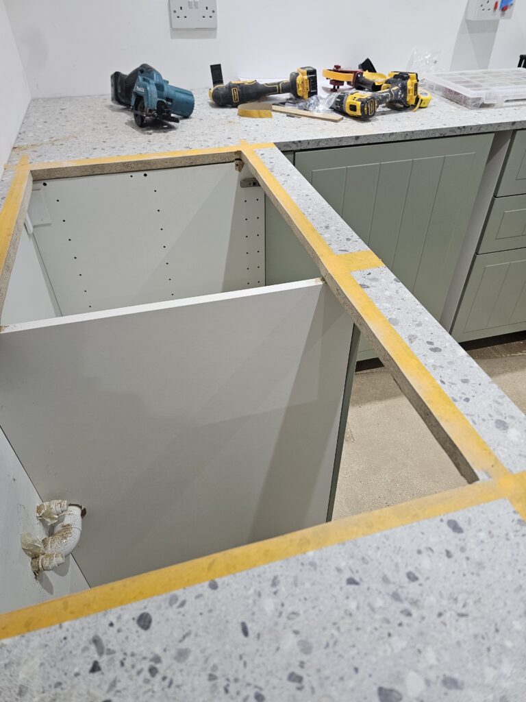 Kitchen worktop prepared for sink cut-out during installation