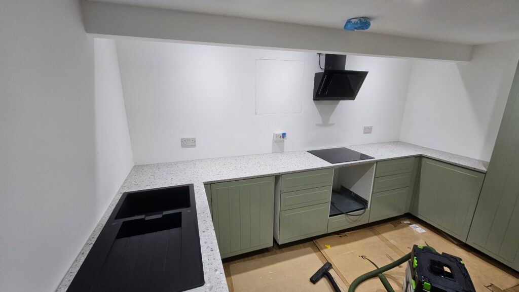 Completed kitchen worktop installation with sink cut-out and hob fitted
