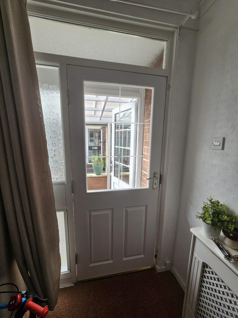 New door and lock installation completed with glazed panel and clean fitted finish