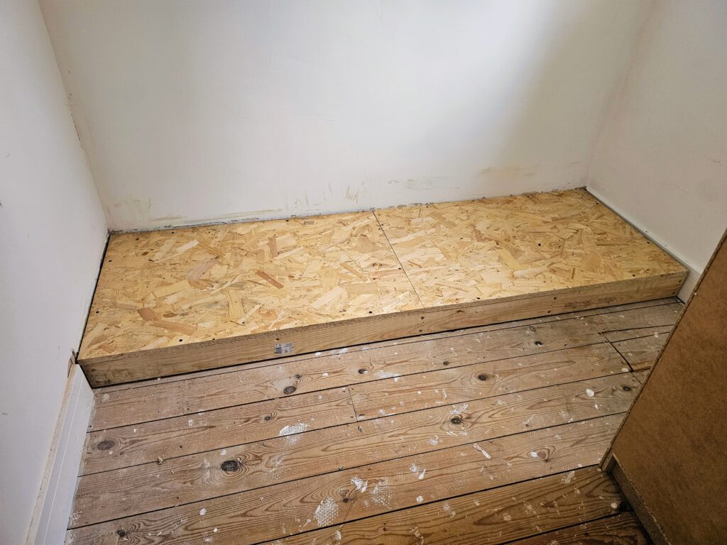 Custom platform base installed and levelled to support IKEA PAX wardrobes for built-in conversion