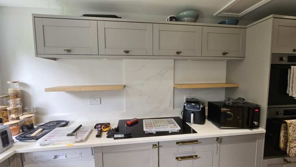 Custom kitchen floating shelves installed with concealed brackets before additional support brackets were added.