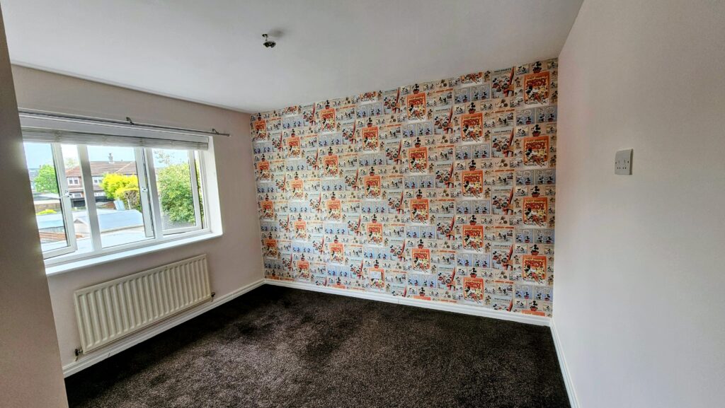 Completed medium bedroom renovation featuring a smooth plastered ceiling and Mickey Mouse feature wallpaper wall