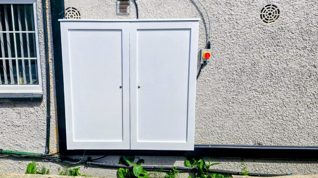 Custom solar inverter and battery storage enclosure with shaker doors in Rochdale