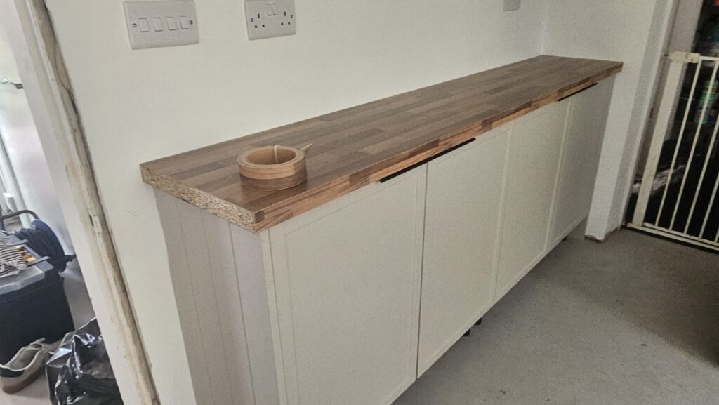 Walnut-effect laminate worktop prepared for front edge banding before final installation