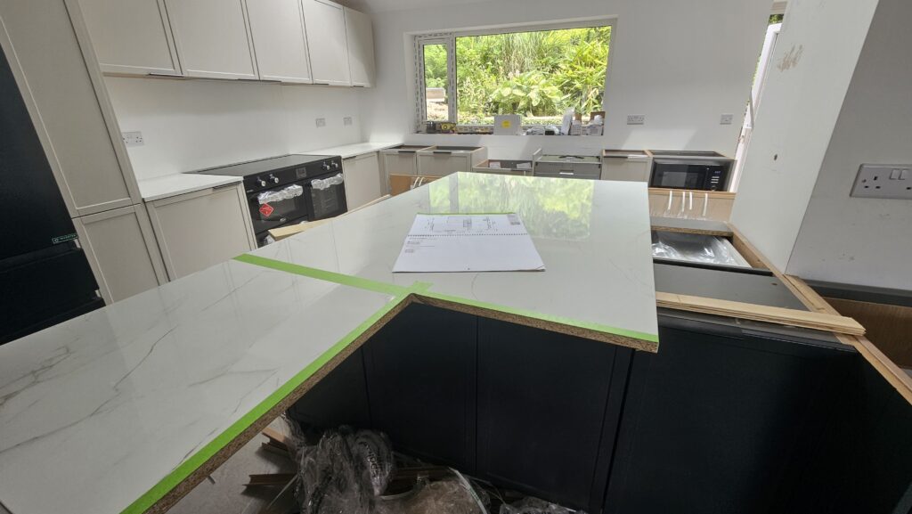Carefully measuring and cutting a laminate kitchen island worktop before the final installation