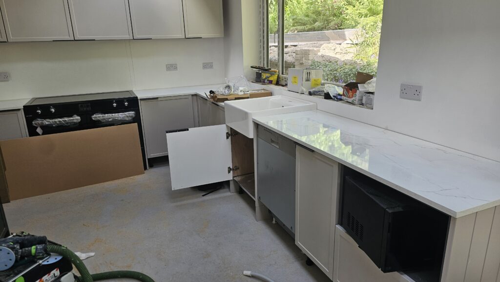 Installing a Belfast sink into a newly fitted laminate worktop before fitting the matching upstand