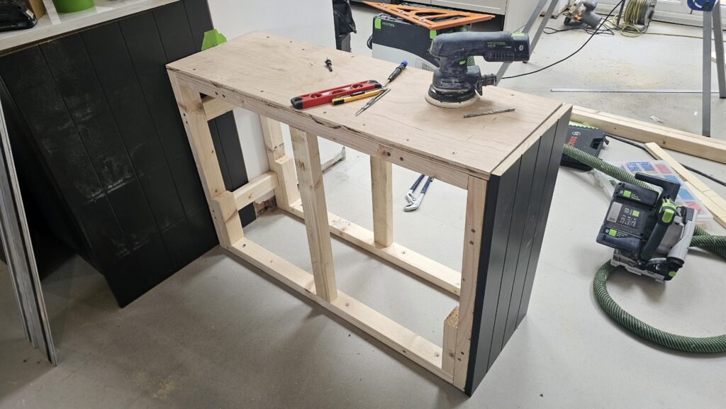 Custom timber frame being built to support a large kitchen island worktop before final panelling