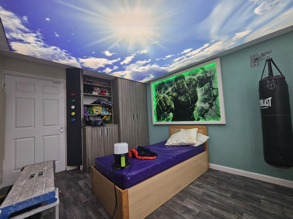 Completed Hulk themed bedroom with illuminated wall art, custom sky ceiling and interactive lighting controls
