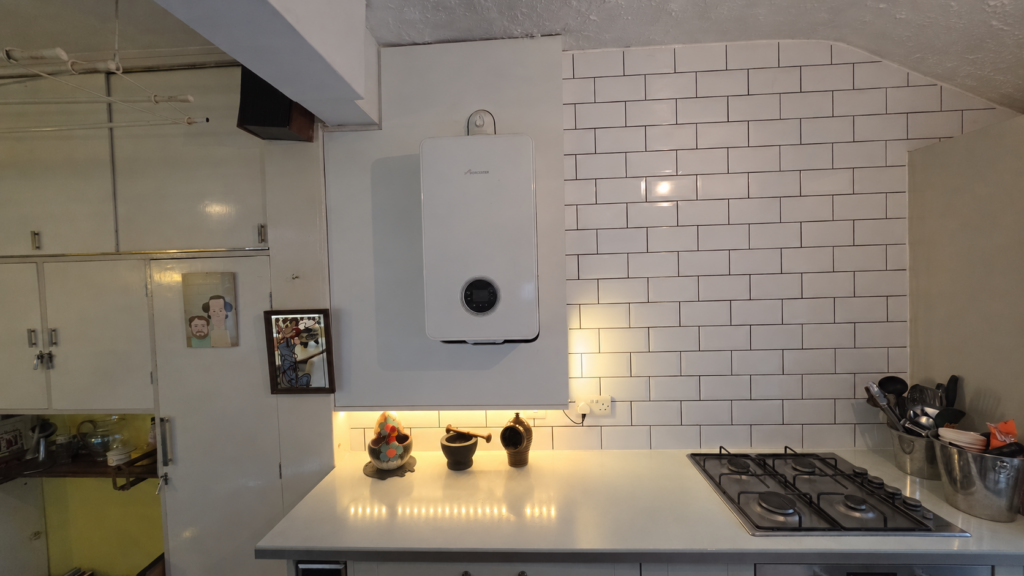 Completed white boiler surround with blue LED lighting underneath and warm lighting along the right side.